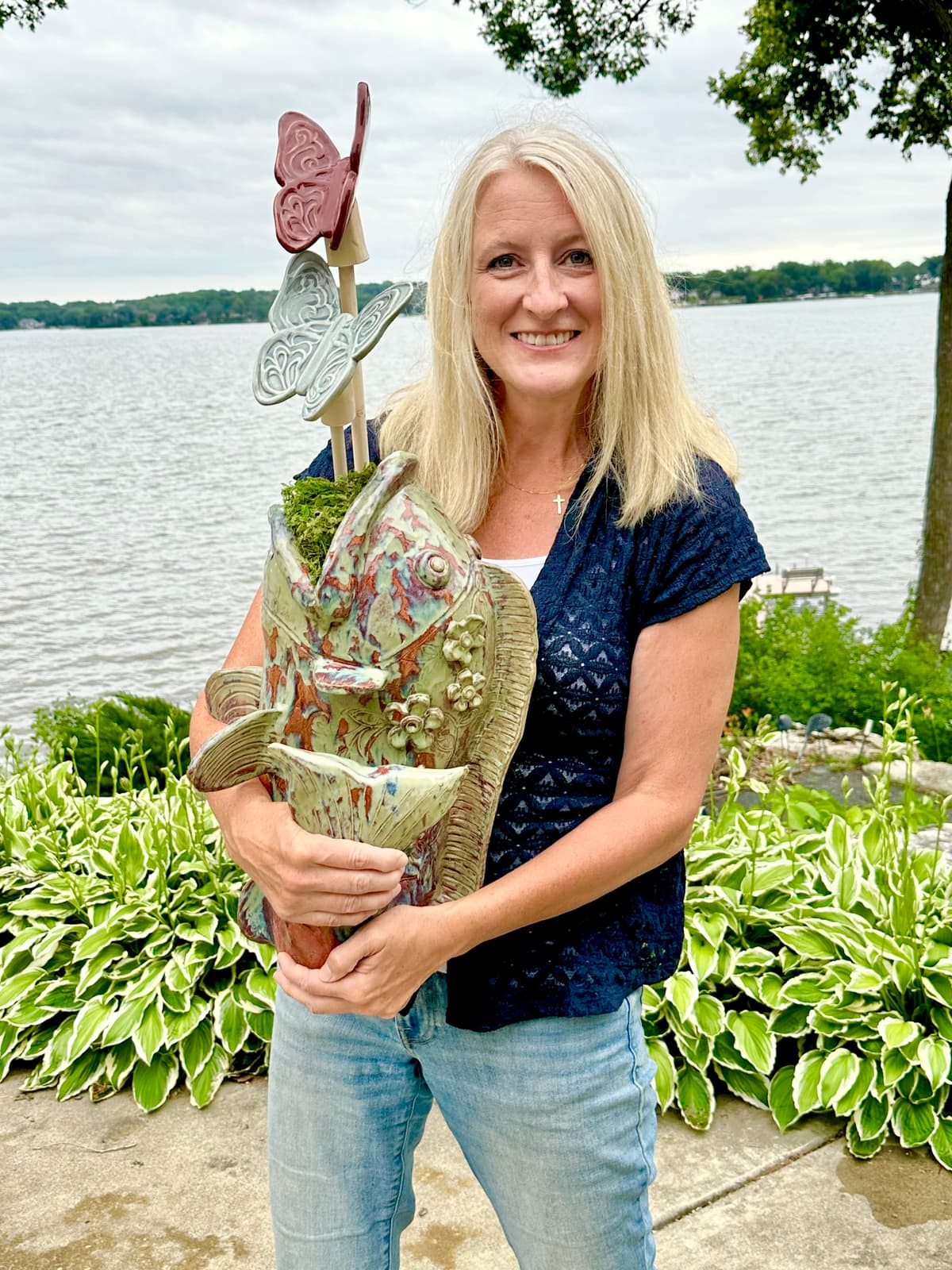 Angie Speed Pottery potter holding a finished piece
